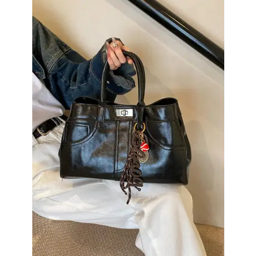 Chic Black Leather Handbag with Charming Pendant and Tassels